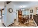 Charming dining room with hardwood floors, a round table, and a stylish chandelier at 8155 Everett E St, Arvada, CO 80005