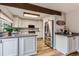 Bright kitchen with white cabinets, stainless steel appliances, and a view of the breakfast nook at 8155 Everett E St, Arvada, CO 80005