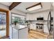 Well-lit kitchen features stainless steel appliances, light wood floors, and stone countertops at 8155 Everett E St, Arvada, CO 80005