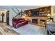 Inviting living room featuring a fireplace with built-in shelves and a comfortable leather couch at 8155 Everett E St, Arvada, CO 80005
