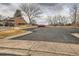 Well-maintained parking area with designated parking spots, landscaped surroundings, and a red car at 8155 Everett E St, Arvada, CO 80005
