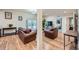 Spacious basement recreation area with leather furniture and hardwood floors at 17624 E Peakview Ave, Aurora, CO 80016