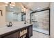 Basement bathroom with double vanity, large mirror and walk-in shower at 17624 E Peakview Ave, Aurora, CO 80016