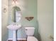 Clean bathroom with pedestal sink and decorative shelf at 17624 E Peakview Ave, Aurora, CO 80016