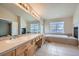 Elegant bathroom with double vanities and a soaking tub at 17624 E Peakview Ave, Aurora, CO 80016