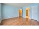 Light blue bedroom with hardwood floors and access to bathroom at 17624 E Peakview Ave, Aurora, CO 80016