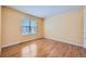 Simple bedroom with hardwood floors and window at 17624 E Peakview Ave, Aurora, CO 80016