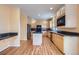 Bright kitchen featuring an island, hardwood floors, and ample cabinetry at 17624 E Peakview Ave, Aurora, CO 80016