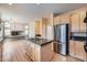 Open kitchen with island and views into Gathering room at 17624 E Peakview Ave, Aurora, CO 80016