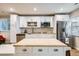 Modern kitchen with white cabinets, stainless steel appliances and butcher block island at 17624 E Peakview Ave, Aurora, CO 80016