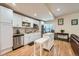 Modern basement kitchen with white cabinets, stainless steel appliances, and island at 17624 E Peakview Ave, Aurora, CO 80016