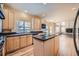 Kitchen with island, hardwood floors, and granite countertops at 17624 E Peakview Ave, Aurora, CO 80016