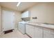 Laundry room with washer, dryer, cabinets, and sink at 17624 E Peakview Ave, Aurora, CO 80016