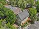 Aerial view of a charming home with lush landscaping, mature trees, a new roof, and a back deck at 351 Bannock St, Denver, CO 80223