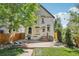 Backyard features brick patio with deck and lush landscaping at 351 Bannock St, Denver, CO 80223