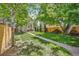 Backyard features brick patio with deck and lush landscaping at 351 Bannock St, Denver, CO 80223