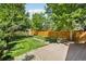 Backyard features brick patio with deck and lush landscaping at 351 Bannock St, Denver, CO 80223