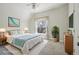 Bright staged bedroom featuring a ceiling fan, large window, and ample natural light at 351 Bannock St, Denver, CO 80223