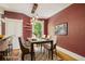 Elegant dining room with red accent wall and modern pendant lighting at 351 Bannock St, Denver, CO 80223