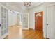 Bright foyer with hardwood floors, detailed trim, glass paneled doors, and a classic chandelier at 351 Bannock St, Denver, CO 80223