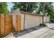 A detached garage featuring horizontal plank fencing, as well as traditional siding and a single access door at 351 Bannock St, Denver, CO 80223