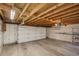 View of attached garage showcasing its concrete floor, overhead lighting, and automatic door with an exposed rafter ceiling at 351 Bannock St, Denver, CO 80223