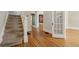 Open hallway features hardwood floors, a staircase, and access to multiple rooms with original trim at 351 Bannock St, Denver, CO 80223