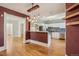 Open kitchen and dining area with hardwood floors, stylish lighting, and modern stainless appliances at 351 Bannock St, Denver, CO 80223