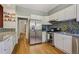 Bright kitchen featuring stainless steel appliances, granite countertops, and stylish backsplash at 351 Bannock St, Denver, CO 80223