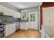 Well-lit kitchen with granite counters, stainless appliances, and mosaic tile backsplash at 351 Bannock St, Denver, CO 80223