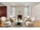 A cozy living room featuring neutral furnishings, fireplace and hardwood floors at 351 Bannock St, Denver, CO 80223