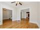 Spacious living room with hardwood floors, classic trim, and views into other rooms with ceiling fan at 351 Bannock St, Denver, CO 80223