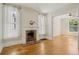 Cozy living room with hardwood floors, fireplace, and natural light from sheer-curtained windows at 351 Bannock St, Denver, CO 80223