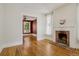 Inviting living room with hardwood floors, a fireplace, and view into a room with a burgundy wall at 351 Bannock St, Denver, CO 80223