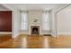 Elegant living room featuring hardwood floors, a fireplace, and large windows with sheer curtains at 351 Bannock St, Denver, CO 80223