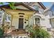 Inviting front porch with seating, mature trees and beautiful landscaping leading to the front door at 351 Bannock St, Denver, CO 80223