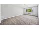 Cozy bedroom featuring a large window, carpet, and an air conditioner at 610 S Alton Way # 7C, Denver, CO 80247
