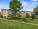 Apartment building in Windsor Gardens with lush green landscaping, mature trees, and walking paths at 610 S Alton Way # 7C, Denver, CO 80247