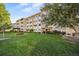 Low-rise residential condo building with well-maintained lawn and verdant landscaping at 610 S Alton Way # 7C, Denver, CO 80247