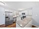 Updated kitchen featuring granite countertops, stainless steel appliances, and white cabinets at 610 S Alton Way # 7C, Denver, CO 80247