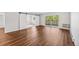 Living room featuring hardwood floors, barn doors, and a sliding glass door to the balcony at 610 S Alton Way # 7C, Denver, CO 80247