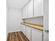 Pantry featuring wood floors, white cabinets, and wood countertop at 610 S Alton Way # 7C, Denver, CO 80247