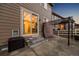Cozy backyard with steps leading to a concrete patio, a metal pergola, and view of interior through sliding glass doors at 2633 Garganey Dr, Castle Rock, CO 80104