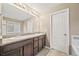 Bathroom with double sinks, granite counters, and tile floors at 2633 Garganey Dr, Castle Rock, CO 80104