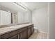 Bathroom with a large mirror, granite counters, and a shower at 2633 Garganey Dr, Castle Rock, CO 80104