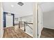 Upstairs hallway with wood floors, white trim, and access to multiple bedrooms and bathrooms at 2633 Garganey Dr, Castle Rock, CO 80104