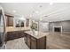 Eat in kitchen boasting generous granite counters, an island, and a view of the living room at 2633 Garganey Dr, Castle Rock, CO 80104