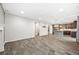 Open concept living room with wood-look tile, flowing into kitchen at 2633 Garganey Dr, Castle Rock, CO 80104