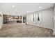 Open concept living space with tile floors and seamless access to a kitchen with island and modern appliances at 2633 Garganey Dr, Castle Rock, CO 80104
