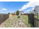 Backyard featuring a wooden fence, playset, and a partially grass-covered yard at 17464 Crestview Ct, Monument, CO 80132